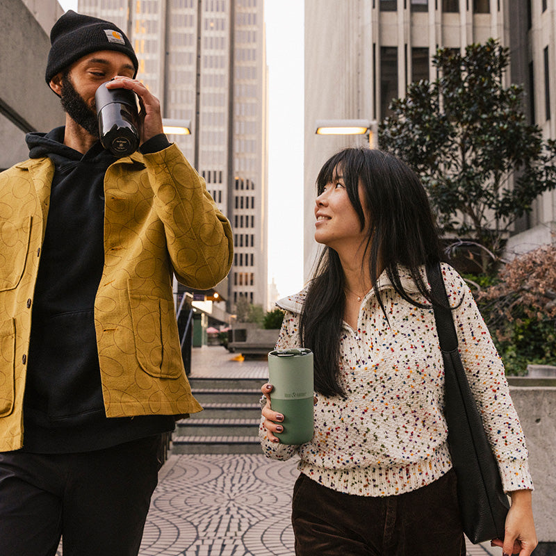 16oz-rise-tumbler-y6 16oz_rise_tumbler_black_iceberg_couple_drink_city_street_square.jpg